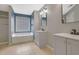 This bathroom features a soaking tub, window and gray vanity with dark hardware at 148 Shady View Pl, Lawrenceville, GA 30044