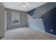 Bedroom featuring a geometric accent wall with ceiling fan and carpeted floor, offering a modern and inviting space at 148 Shady View Pl, Lawrenceville, GA 30044