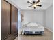 Neutral bedroom featuring a ceiling fan, floating shelves, closet and tile flooring at 148 Shady View Pl, Lawrenceville, GA 30044