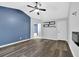 Bedroom featuring wood floors, vaulted ceilings, modern accent wall, and a glimpse of the bathroom at 148 Shady View Pl, Lawrenceville, GA 30044