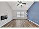 Bedroom featuring wood floors, vaulted ceilings, modern accent wall, and natural light from a window at 148 Shady View Pl, Lawrenceville, GA 30044