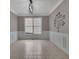 Neutral dining room features white wainscoting, a chandelier, and a window at 148 Shady View Pl, Lawrenceville, GA 30044