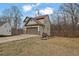 Rear view of this lovely home featuring an attached two-car garage and partially wooded backyard at 148 Shady View Pl, Lawrenceville, GA 30044