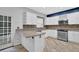 Well-lit kitchen featuring white cabinets, stainless steel appliances, tile backsplash, and French doors at 148 Shady View Pl, Lawrenceville, GA 30044