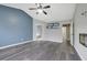 Open-concept living room showcases wood floors, vaulted ceilings, custom shelving and flows to an attached bathroom at 148 Shady View Pl, Lawrenceville, GA 30044