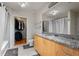 Well-lit bathroom featuring a granite countertop, a bathtub, and a separate walk-in closet at 250 Pharr Ne Rd # 607, Atlanta, GA 30305