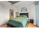 Comfortable bedroom with hardwood floors, accent art, and ensuite bath at 250 Pharr Ne Rd # 607, Atlanta, GA 30305