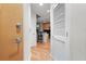 Bright hallway with hardwood floors leading to the kitchen and white doors at 250 Pharr Ne Rd # 607, Atlanta, GA 30305