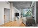 Bright living room featuring large windows, hardwood floors, and contemporary design at 250 Pharr Ne Rd # 607, Atlanta, GA 30305