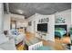 Inviting living room featuring hardwood floors, modern decor, and an open layout to the kitchen and adjacent bedroom at 250 Pharr Ne Rd # 607, Atlanta, GA 30305