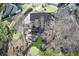 Aerial view of a home with a backyard with a deck, patio with fire pit, waterfall, and lawn at 322 Berkshire Trce, Canton, GA 30115