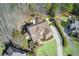 Overhead view of a brick home with manicured lawns and surrounding trees at 322 Berkshire Trce, Canton, GA 30115