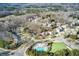 An elevated angle of neighborhood houses, community pool, and surrounding wooded area at 322 Berkshire Trce, Canton, GA 30115
