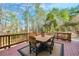 Back deck features an outdoor table, chairs, an umbrella and a natural setting at 322 Berkshire Trce, Canton, GA 30115
