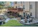 Inviting backyard featuring a spacious deck, stone patio with a fire pit, and a hot tub at 322 Berkshire Trce, Canton, GA 30115