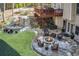 Charming backyard with a fire pit, stone patio, and a landscaped waterfall feature at 322 Berkshire Trce, Canton, GA 30115