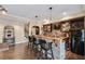 Entertainment bar area with seating, brick accents, custom cabinetry, and beverage refrigerator at 322 Berkshire Trce, Canton, GA 30115