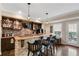 Basement bar featuring stone accents, wood countertop, brick backsplash and pendant lighting at 322 Berkshire Trce, Canton, GA 30115