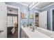 Well-lit bathroom with a dual-access vanity, and a view of the Primary suite and a separate bedroom at 322 Berkshire Trce, Canton, GA 30115