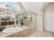 The bathroom features a soaking tub, glass enclosed shower and modern fixtures at 322 Berkshire Trce, Canton, GA 30115
