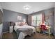 Cozy bedroom with gray walls, a bed, a desk, and colorful accents at 322 Berkshire Trce, Canton, GA 30115