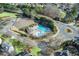 Aerial view of a community pool with chairs, trees, and surrounding neighborhood at 322 Berkshire Trce, Canton, GA 30115