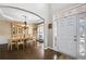 Elegant dining room featuring hardwood floors, decorative lighting, and a view of the front entrance at 322 Berkshire Trce, Canton, GA 30115
