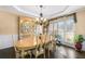 Charming dining room with hardwood floors, a chandelier, and a window with natural light at 322 Berkshire Trce, Canton, GA 30115
