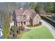 Aerial view of a two-story brick home, lush landscaping, and long driveway at 322 Berkshire Trce, Canton, GA 30115