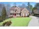 Brick house with a red door, landscaped lawn, and a long driveway at 322 Berkshire Trce, Canton, GA 30115