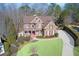 Stately two-story brick home featuring a well-manicured lawn and mature trees at 322 Berkshire Trce, Canton, GA 30115