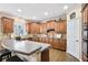 Well-lit kitchen featuring wood cabinets, updated countertops, and an island at 322 Berkshire Trce, Canton, GA 30115