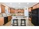 Charming kitchen with stone tile backsplash, stainless steel appliances, and island seating at 322 Berkshire Trce, Canton, GA 30115