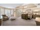 Spacious main bedroom featuring a sitting area, tray ceiling and multiple windows at 322 Berkshire Trce, Canton, GA 30115
