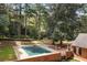 An elevated view showcases a large inground pool, patio furniture, and lush landscaping at 1790 Garraux Nw Rd, Atlanta, GA 30327