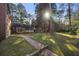 Brick pathway to a home with a screened porch and large backyard at 1790 Garraux Nw Rd, Atlanta, GA 30327