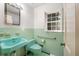 Retro bathroom with mint green tile and vintage fixtures at 1790 Garraux Nw Rd, Atlanta, GA 30327
