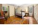 Bright bedroom featuring a wooden bed frame and area rug at 1790 Garraux Nw Rd, Atlanta, GA 30327