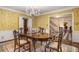 Formal dining room with floral wallpaper, chandelier and access to entry at 1790 Garraux Nw Rd, Atlanta, GA 30327