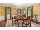 Formal dining room with floral wallpaper, chandelier, and wood table at 1790 Garraux Nw Rd, Atlanta, GA 30327