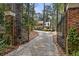 Stone driveway leading to home through wrought iron gates at 1790 Garraux Nw Rd, Atlanta, GA 30327