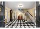 Checkerboard floor entryway with staircase and antique furniture at 1790 Garraux Nw Rd, Atlanta, GA 30327