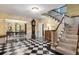 Checkerboard floor entryway with staircase and view to dining room at 1790 Garraux Nw Rd, Atlanta, GA 30327
