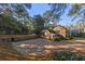 Brick home with large driveway, detached garage, and mature trees at 1790 Garraux Nw Rd, Atlanta, GA 30327