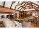 Gathering room with exposed beams, brick fireplace, hardwood floors, and built-ins at 1790 Garraux Nw Rd, Atlanta, GA 30327