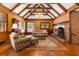 Gathering room with exposed beams, brick fireplace, and hardwood floors at 1790 Garraux Nw Rd, Atlanta, GA 30327
