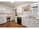 White kitchen features ample counter space and storage at 1790 Garraux Nw Rd, Atlanta, GA 30327