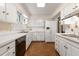Bright kitchen with white cabinets and terracotta tile floor at 1790 Garraux Nw Rd, Atlanta, GA 30327