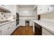 Efficient kitchen with white cabinets, double oven, and tile floor at 1790 Garraux Nw Rd, Atlanta, GA 30327