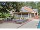 Brick patio with lounge chairs and screened porch at 1790 Garraux Nw Rd, Atlanta, GA 30327